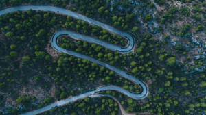 upper-aerial-view-of-road-curves-in-a-forest - Edited